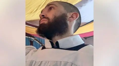 Justin Evans, a man with a black beard.