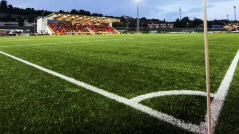 Getty Image of the Ryan McBride Brandywell Stadium. A corner flag is visible near a large green pitch with a half-full stadium in vision. 
