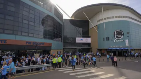 BBC CWR The front of the CBS Arena stadium in Coventry showing Coventry City fans and other people walking outside