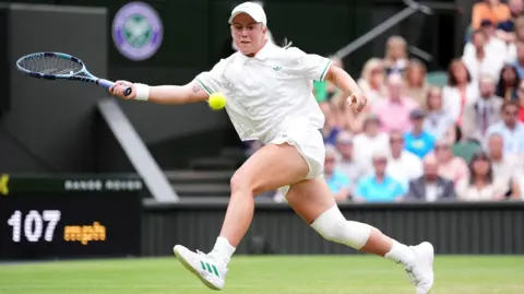 PA Media Sonay Kartal hitting a ball at Wimbledon.