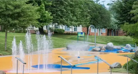 Worcester City Council Yellow and blue splashpad with water fountains
