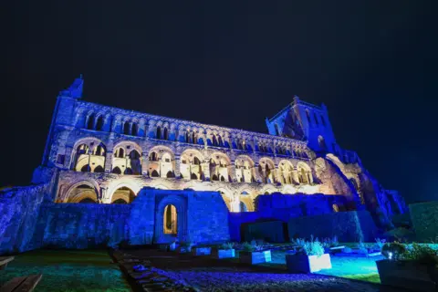 Stuart Cobley/SBC Jedburgh Abbey lit up in blue lighting for a special event