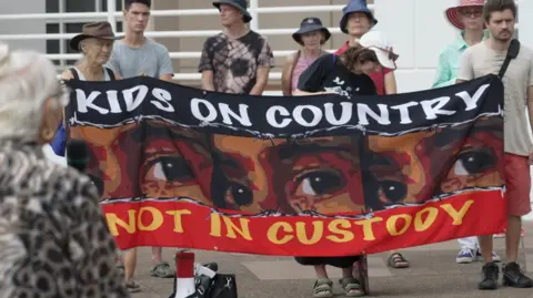 BBC/Simon Atkinson A protestation  was held extracurricular  the Northern Territory's parliament successful  Darwin arsenic  MPs debated lowering the property  of transgression  work   to 10