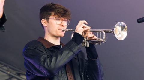 Joshua Bowman, 18, playing the trumpet