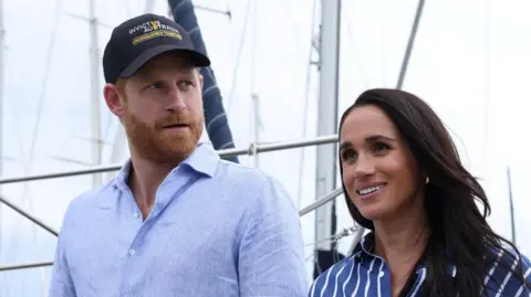 Reuters Britain's Prince Harry and Meghan, the Duke and Duchess of Sussex, disembark after sailing on Sydney Harbour with veterans from the Invictus Australia community, in Sydney, Australia.