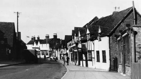 The Knowle Society An old black and white picture of Knowle's high street.