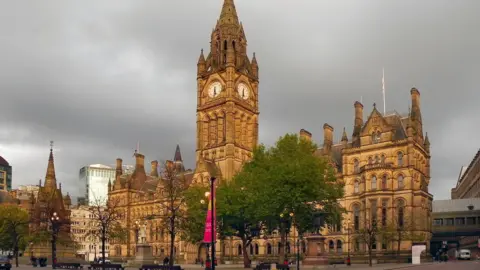 Manchester Town Hall is a multi-storey historic building including a clock tower.
