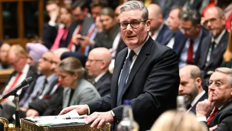 Sir Keir Starmer standing and speaking at Prime Minister's Question time in the House of Commons today