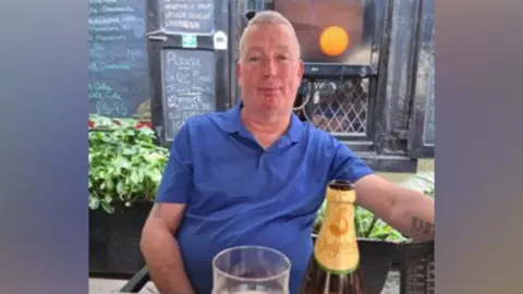 Leicestershire Police Man sitting in pub wearing blue shirt