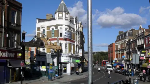 Exterior still of area outside Woolwich Arsenal station