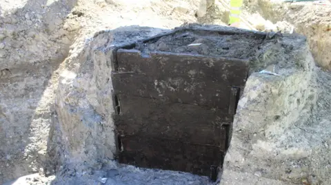 MOLA A well lined with wooden boards to support the structure and stop it caving in