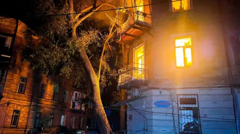State Emergency Service Odesa/ Reuters A burning apartment building after it was hit by a Russian drone strike, amid Russia's attack on Odesa