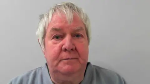 North Yorkshire Police A police mugshot of Rodney Abbott, an elderly man with short grey hair wearing a grey jumper.