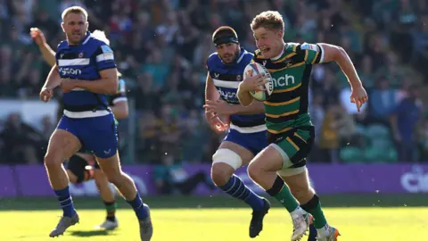 Fin Smith of Northampton Saints charges upfield to score their first try during the Gallagher PREM match between Northampton Saints and Bath Rugby.