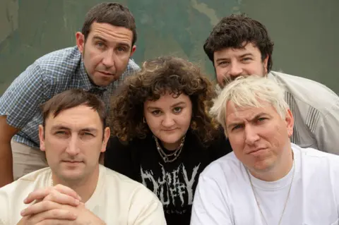 The Mary Wallopers Band members pose for a group photo.