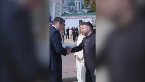 Andy Burnham shaking hands with Ukrainian President Volodymyr Zelensky