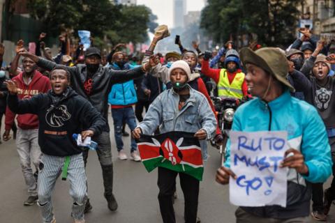 Protesters gesture at anti-riot police during anti-government protests in Nairobi on July 16, 2024