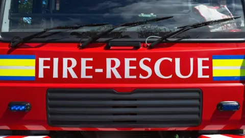 A close-up shot of a red fire engine. 