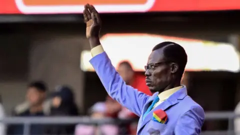 Michel Kuka Mboladinga standing