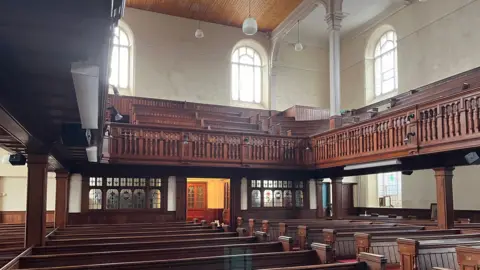 Inside of Penuel Chapel in Carmarthen with wooden benches 