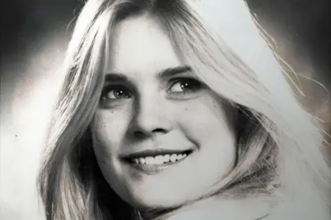 Handout Samantha Ramsay, in a black-and-white studio portrait, with long, fair hair, smiling at the camera