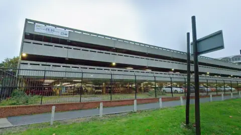 A three-storey concrete car park
