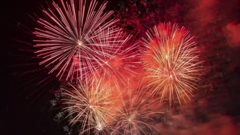 Getty Images Red and orange fireworks in the night sky