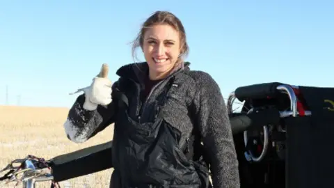 PA Alicia Hempleman-Adams in front of a landed air balloon
