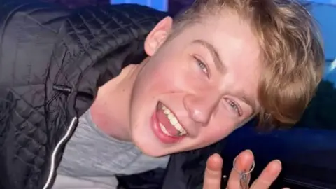 Young blond man smiling holding keys