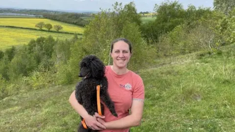 Campaigner Becky Spackman, behind her are the fields where the proposed solar farm would have been