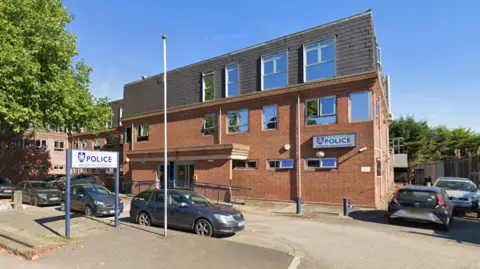 Google The outside of Banbury police station, a three-storey square brick building with half a dozen cars parked outside.