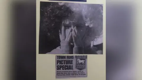 Katie Worby Newspaper cuttings from the day of Ipswich's relegation in 2002, including a picture of Ms Worby - wearing a wig