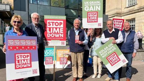 Group of campaigners with placards outside Trowbridge's county hall