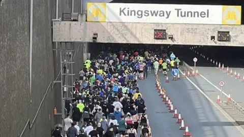 Born to Run Runners go into a closed lane of the Kingsway Tunnel.