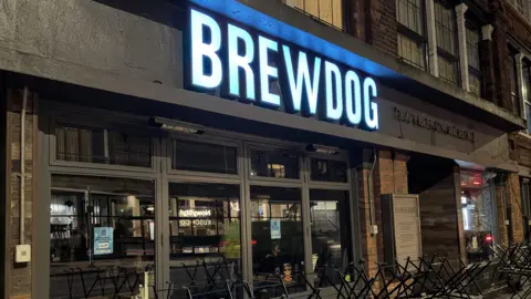 PA Media A Brewdog bar in London with chairs on top of the tables outside the premises.