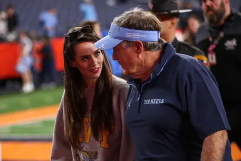 Getty Images Jordon Hudson photographed next to Bill Belichick on the sidelines before a game against Syracuse University 
