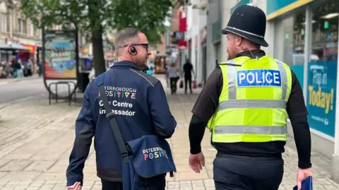 Peterborough Positive Picture of Terry and PC Jay walking together - taken from behind.