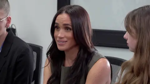 Duchess of Sussex, Meghan, sat between two students
