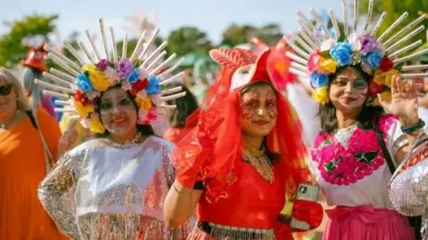 Nene Park Trust Three women wearing colourful traditional outfits