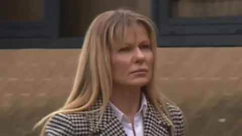 Anna Malgorzata Bogusiewicz is pictured walking into Southampton Crown Court. She is wearing a checked black and white jacket, a white shirt and has shoulder length, blonde hair.