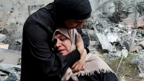 Naima, the grieving mother of Hala Zaarab, a Palestinian newlywed killed in an Israeli air strike, is comforted as she cries, in Khan Younis, southern Gaza, 3 May 2025