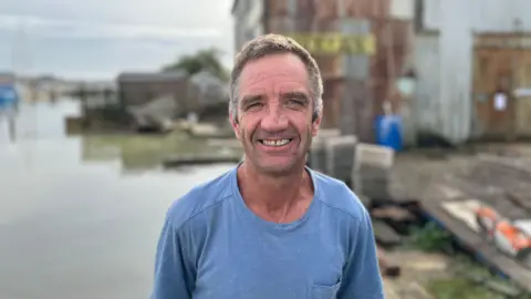 George Carden / BBC Gary McGeown stood in the shipyard