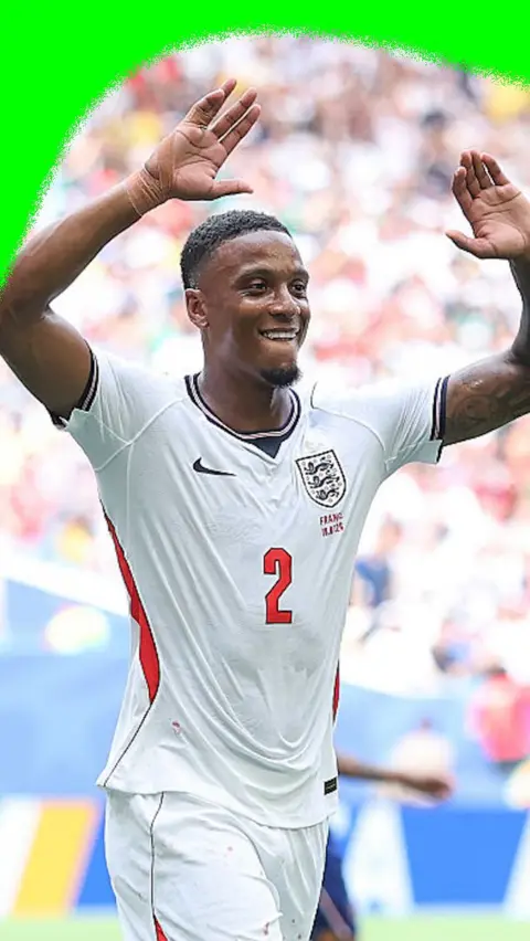 Ezri Konsa high fives a team mate to celebrate scoring England second goal against France.