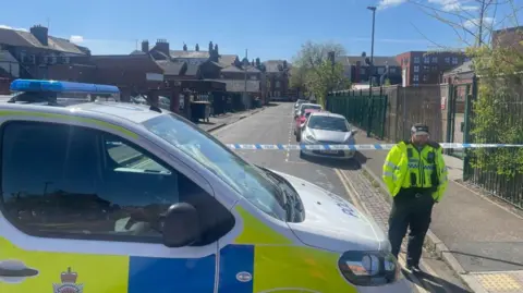 Cordon with police officer standing nearby