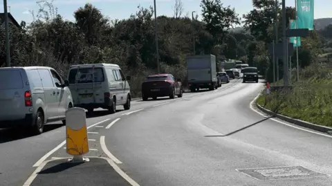 A line of traffic at Windy Corner which is stretching back by several vehicles