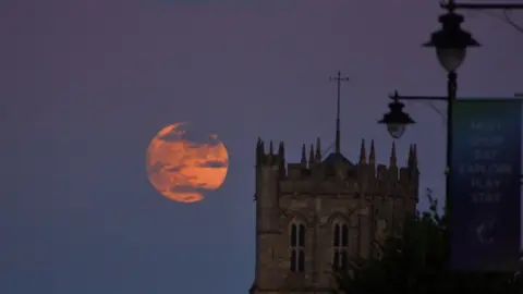 Phillip Denson Strawberry Moon rising beside Christchurch Priory