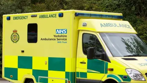 A Yorkshire Ambulance Service ambulance painted with yellow and green checks