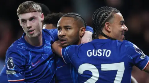 Chelsea players celebrate scoring a goal