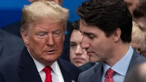 Donald Trump and Justin Trudeau pictured speaking as they attend the NATO summit at the Grove Hotel on December 4, 2019 in Watford, England. 