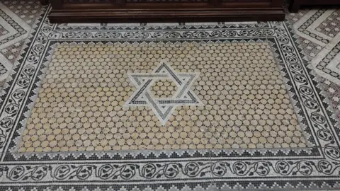 Fiona McCarthy/BBC A mosaic which has been preserved and is in St John's Church